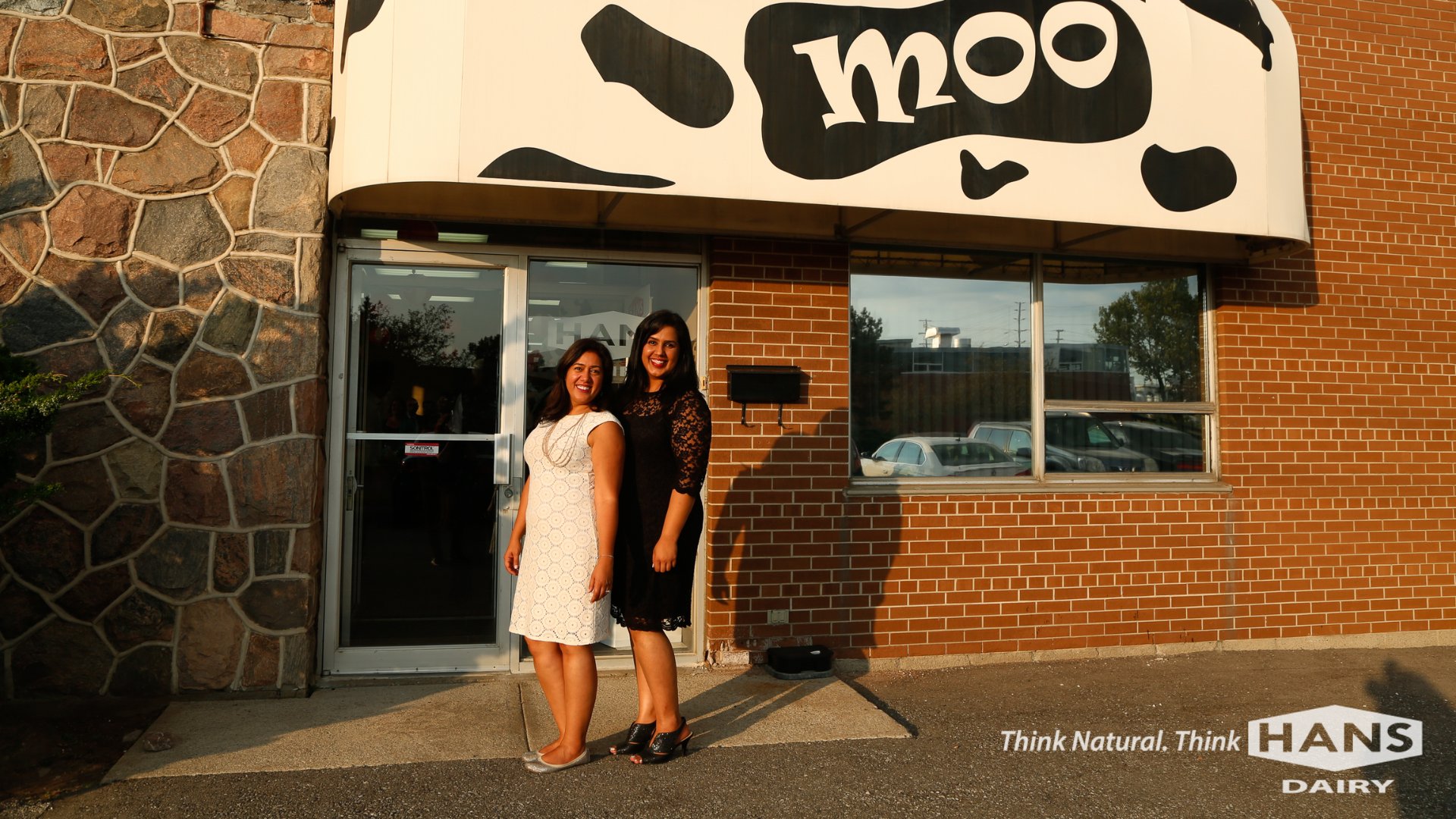 Sarab and Mandeep Hans stand in front of Hans Dairy, their family's South Asian dairy company.